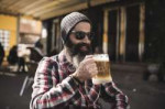 focused177568170-stock-photo-hipster-drinking-beer-at-outdo[...].jpg