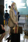 elle-fanning-sports-gucci-glasses-paired-with-a-tan-blazer-[...].jpg