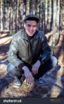 stock-photo-a-guy-in-a-leather-jacket-and-cap-sits-on-a-roa[...].jpg