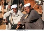 two-egyptian-men-in-a-cattle-market-in-the-nile-valley-bgge[...]